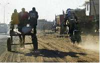 Eric Aubijoux of France overtakes a horse and cart just outside Dakar on the penultimate day of the Paris-Dakar rally in Senegal
